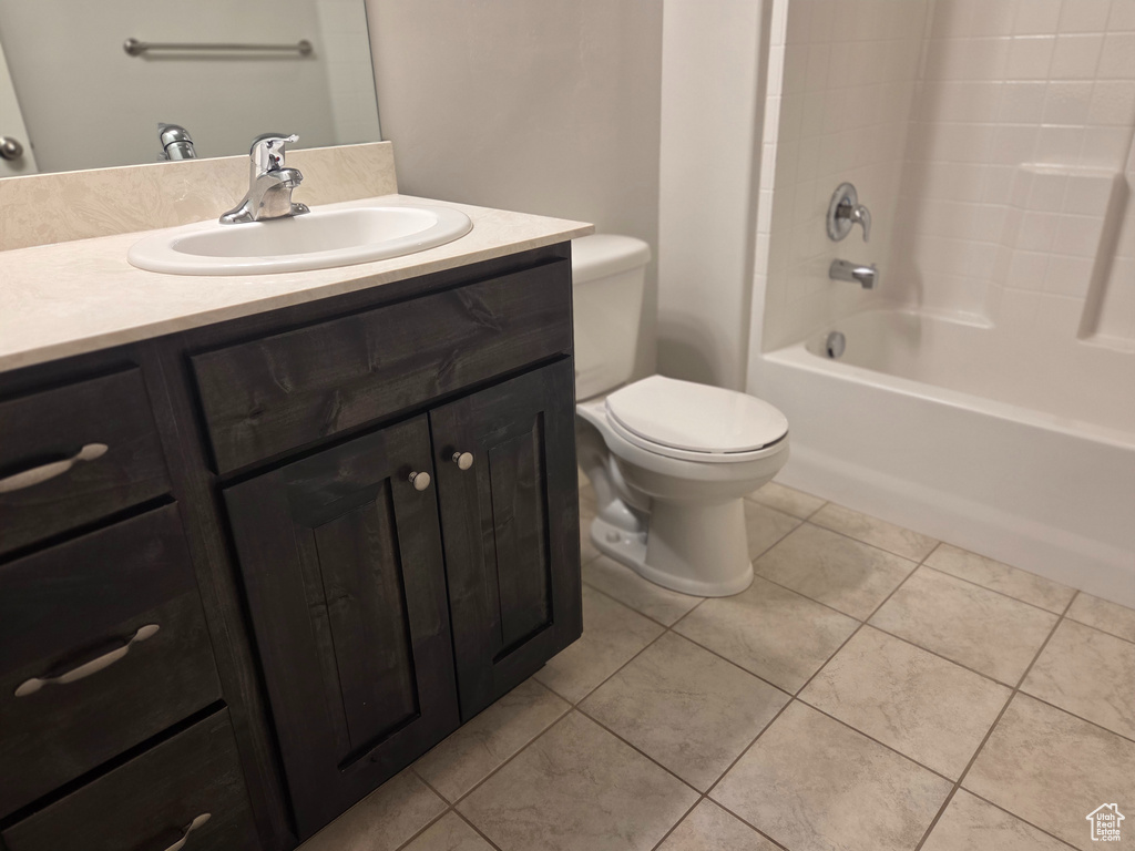 Bathroom with toilet, tile patterned flooring, vanity, and shower / bath combination