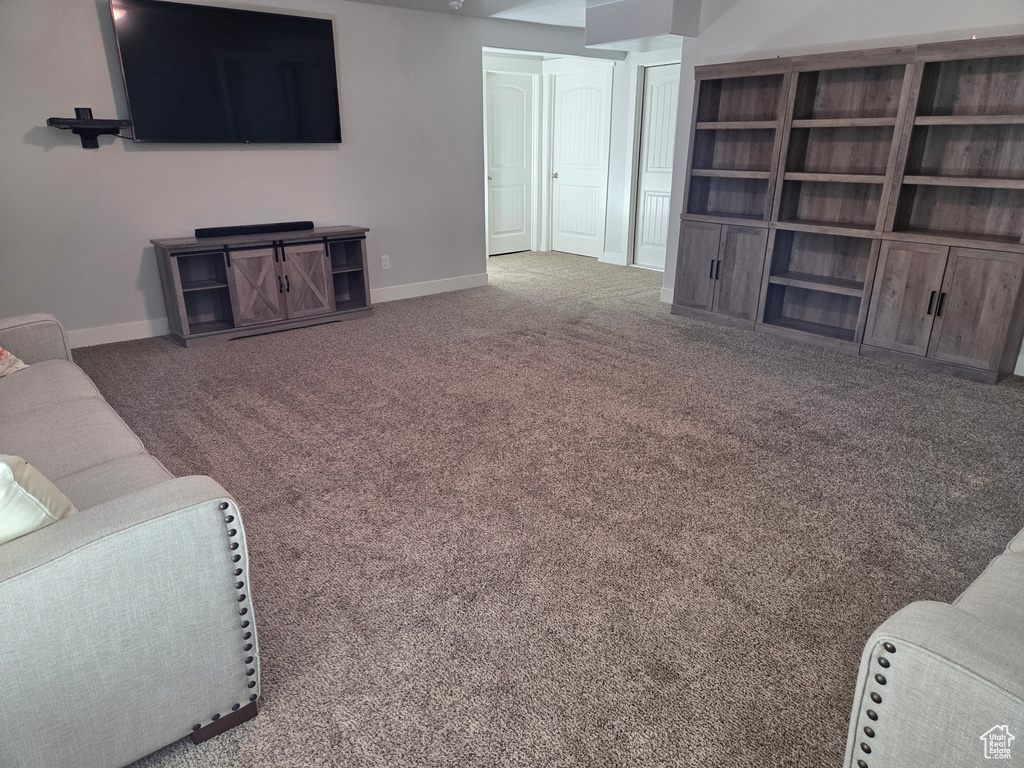 Carpeted living room with baseboards