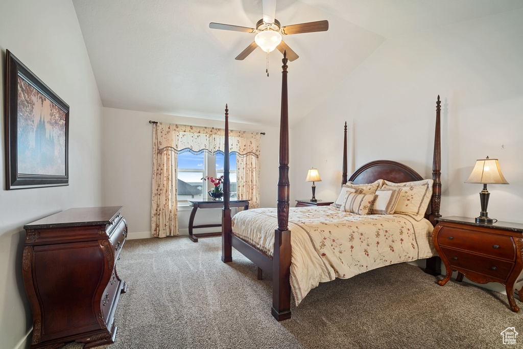 Carpeted bedroom featuring baseboards, a ceiling fan, and lofted ceiling