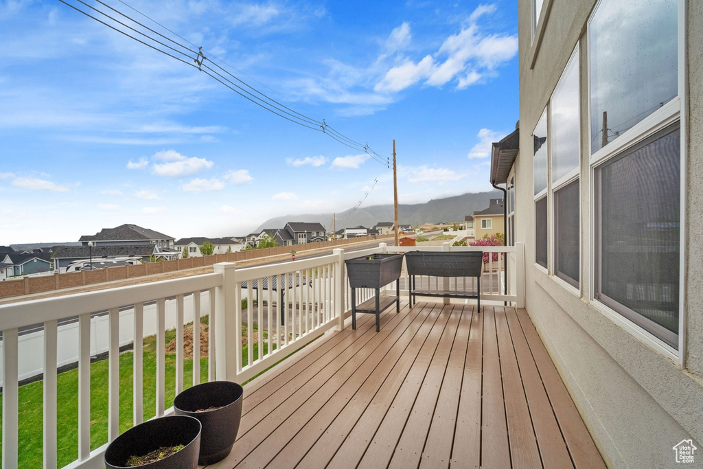 Wooden deck featuring fence and a residential view