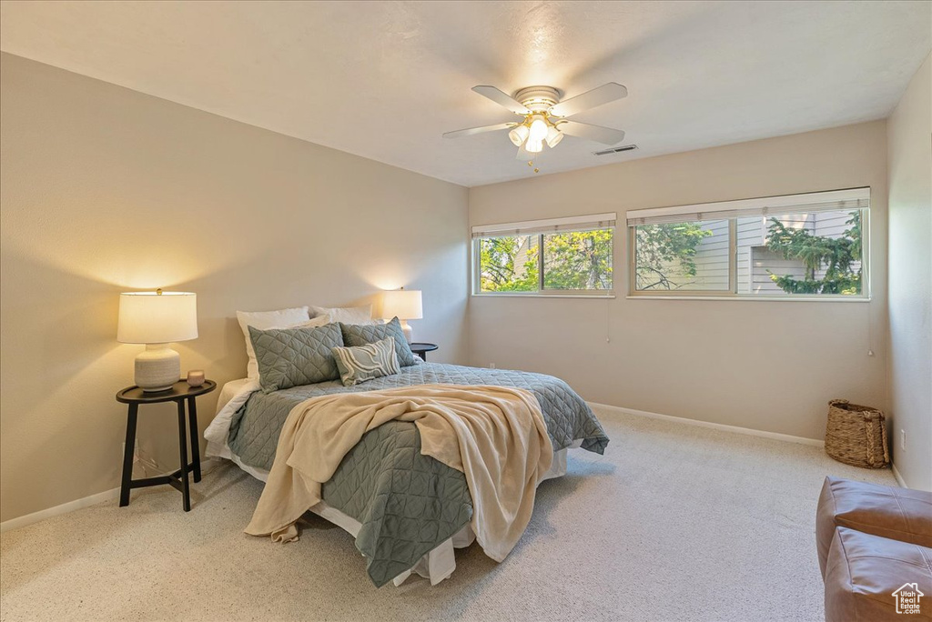 Bedroom with baseboards, a ceiling fan, visible vents, and carpet floors
