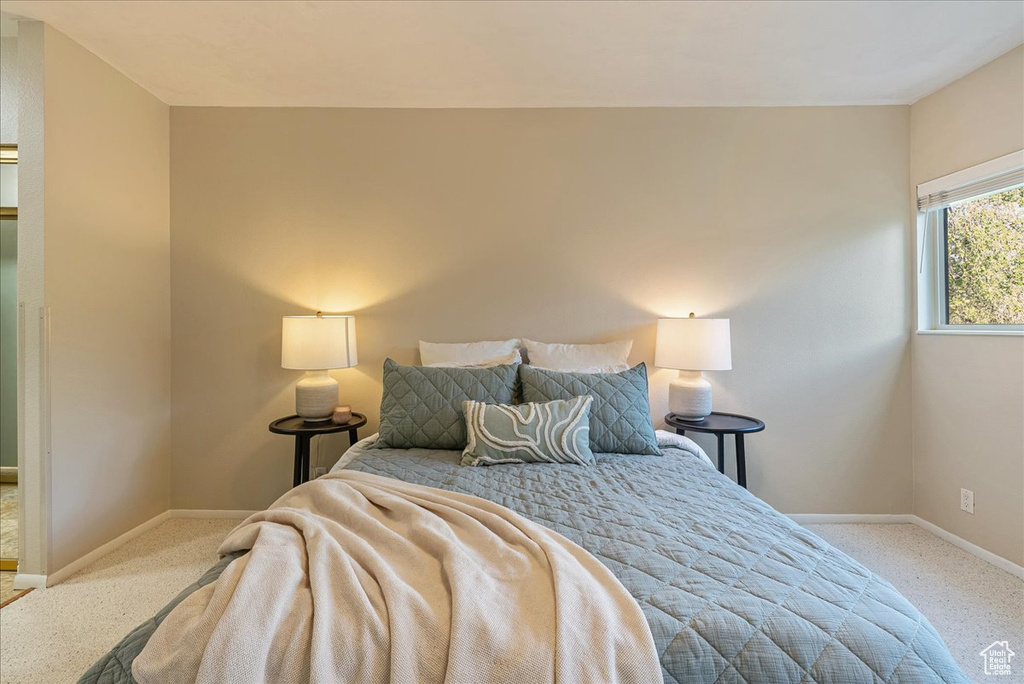 Carpeted bedroom featuring baseboards