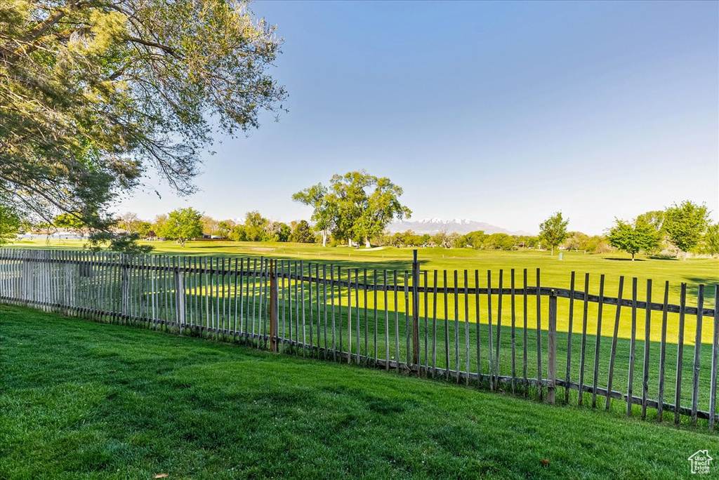 View of yard featuring fence and a mountain view