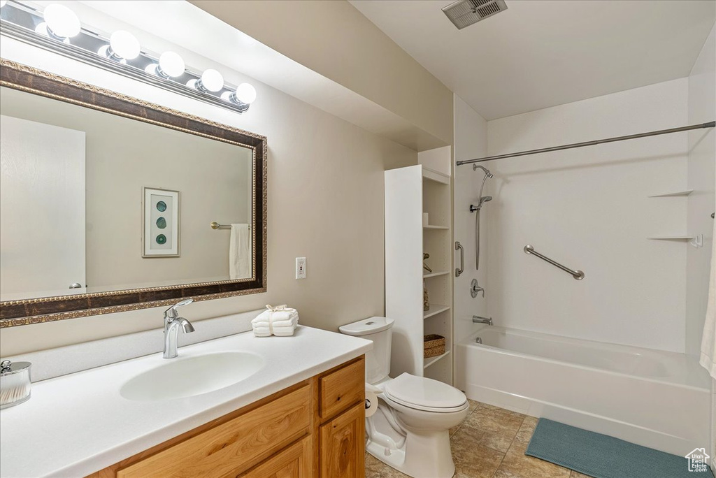 Full bath featuring toilet, shower / washtub combination, vanity, visible vents, and tile patterned flooring