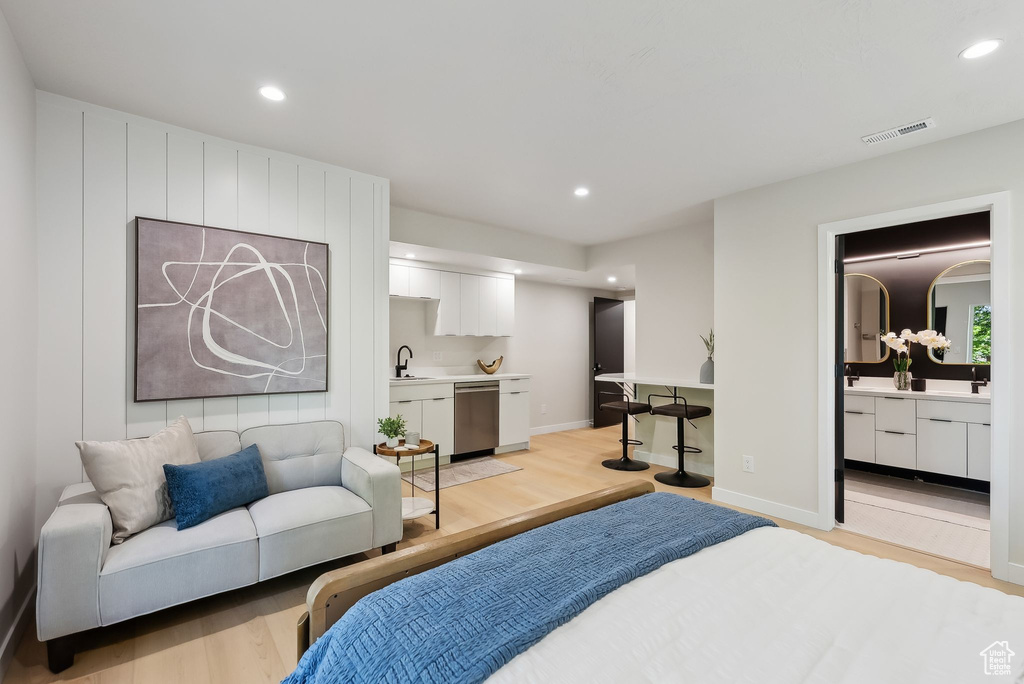 Bedroom with recessed lighting, baseboards, visible vents, a sink, and light wood-type flooring