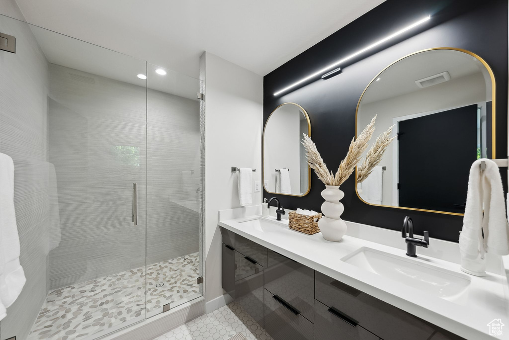 Full bath featuring a sink, tile patterned flooring, a shower stall, and recessed lighting