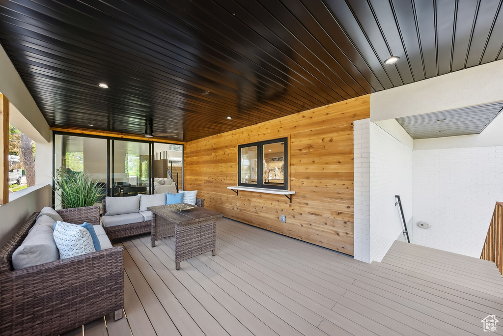 Wooden terrace featuring an outdoor living space