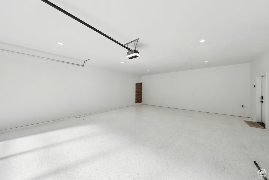 Garage featuring a garage door opener and recessed lighting