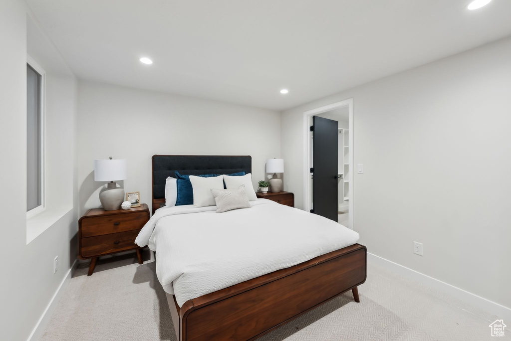 Bedroom with light carpet, baseboards, and recessed lighting