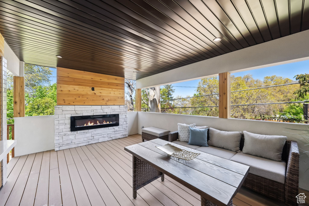 Deck featuring an outdoor living space with a fireplace
