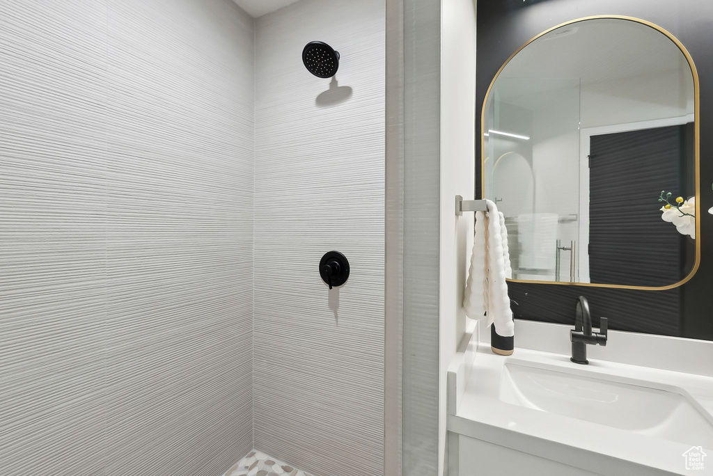Bathroom featuring vanity and a tile shower