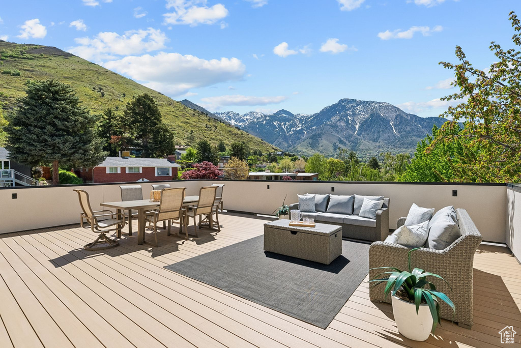 Deck featuring an outdoor hangout area, outdoor dining area, and a mountain view