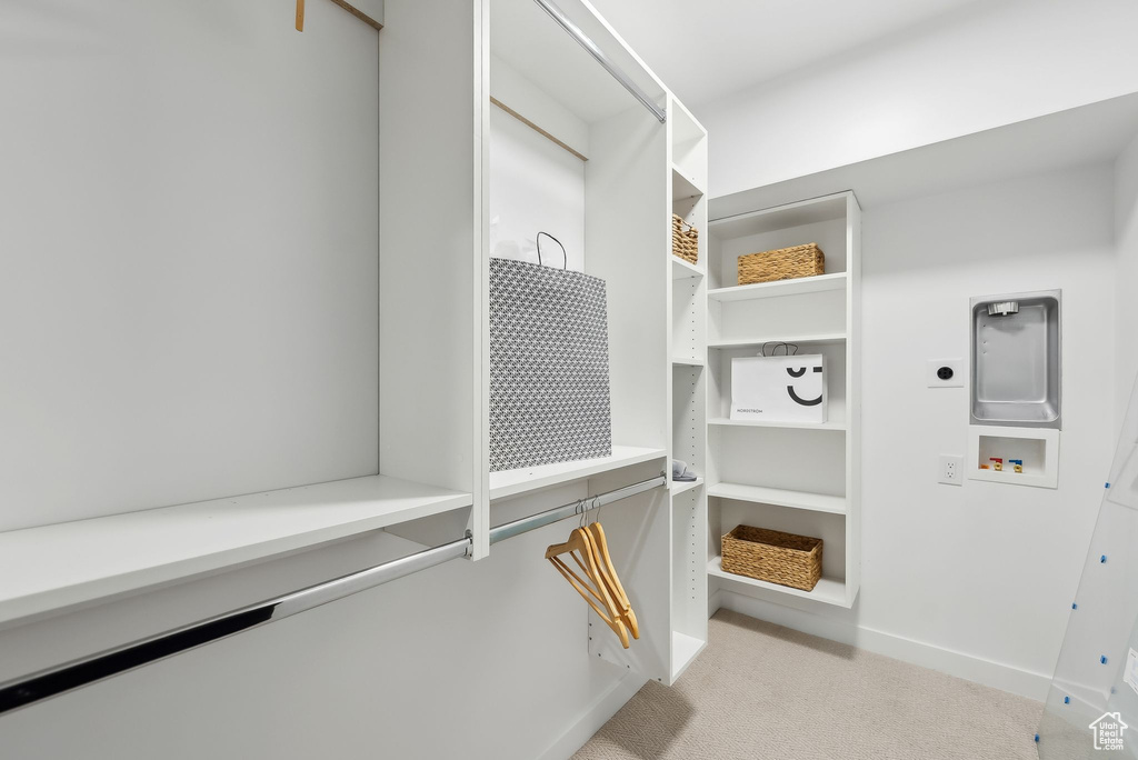Walk in closet with carpet floors