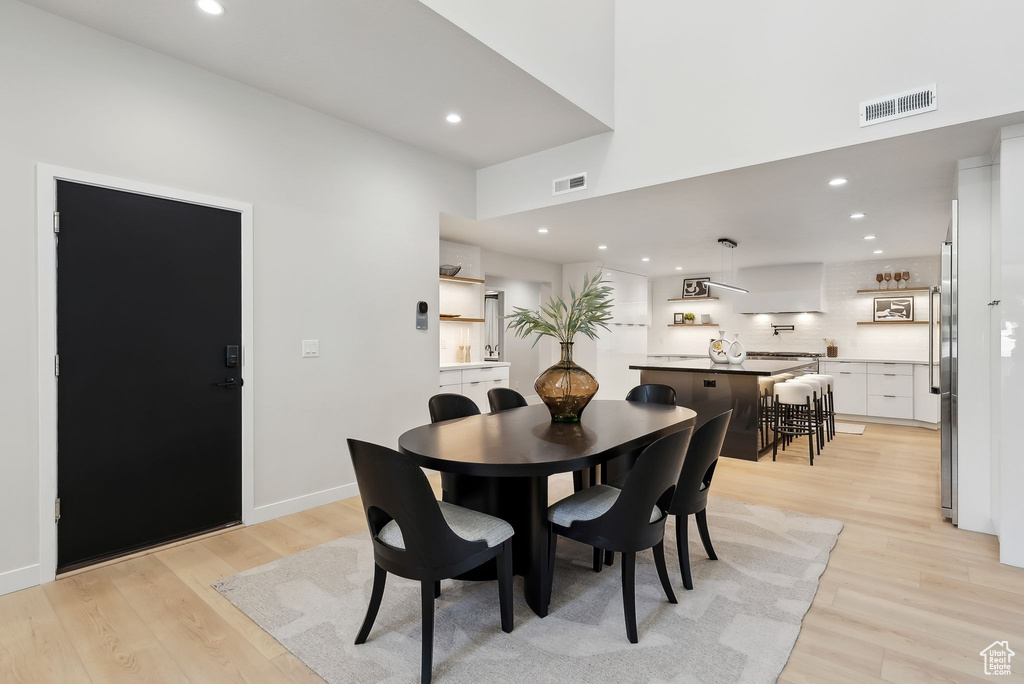 Dining area featuring baseboards, recessed lighting, light wood-style flooring, and visible vents