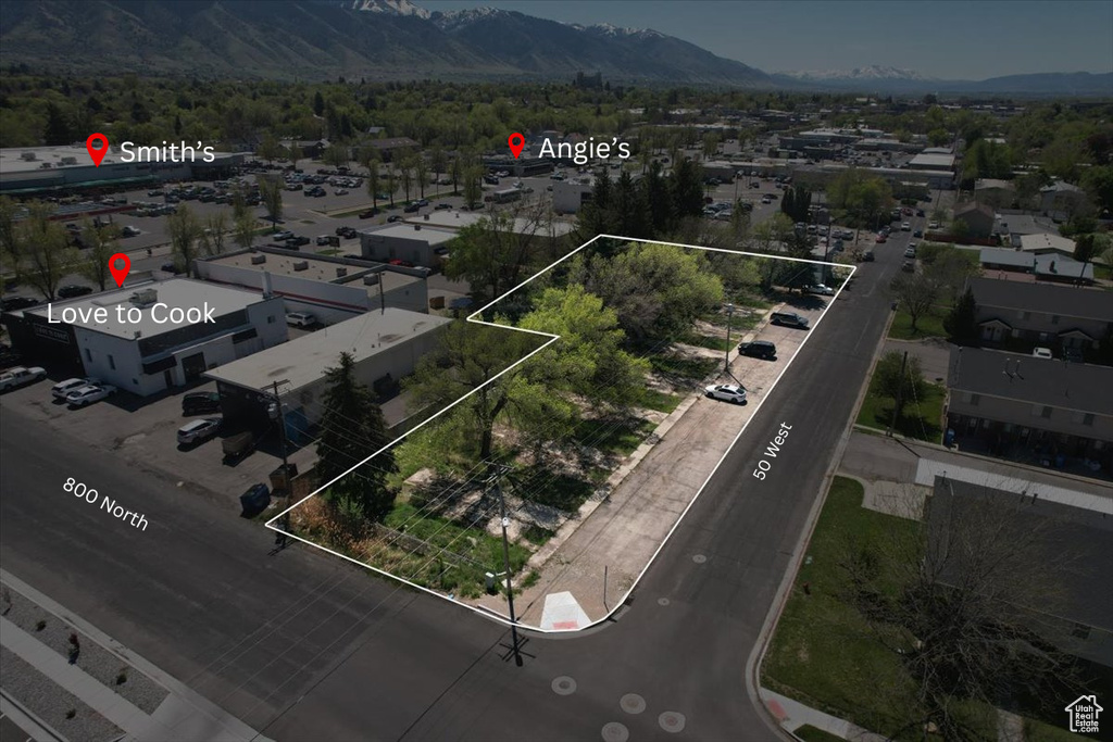 Aerial view of property's location featuring a mountainous background and property boundaries highlighted
