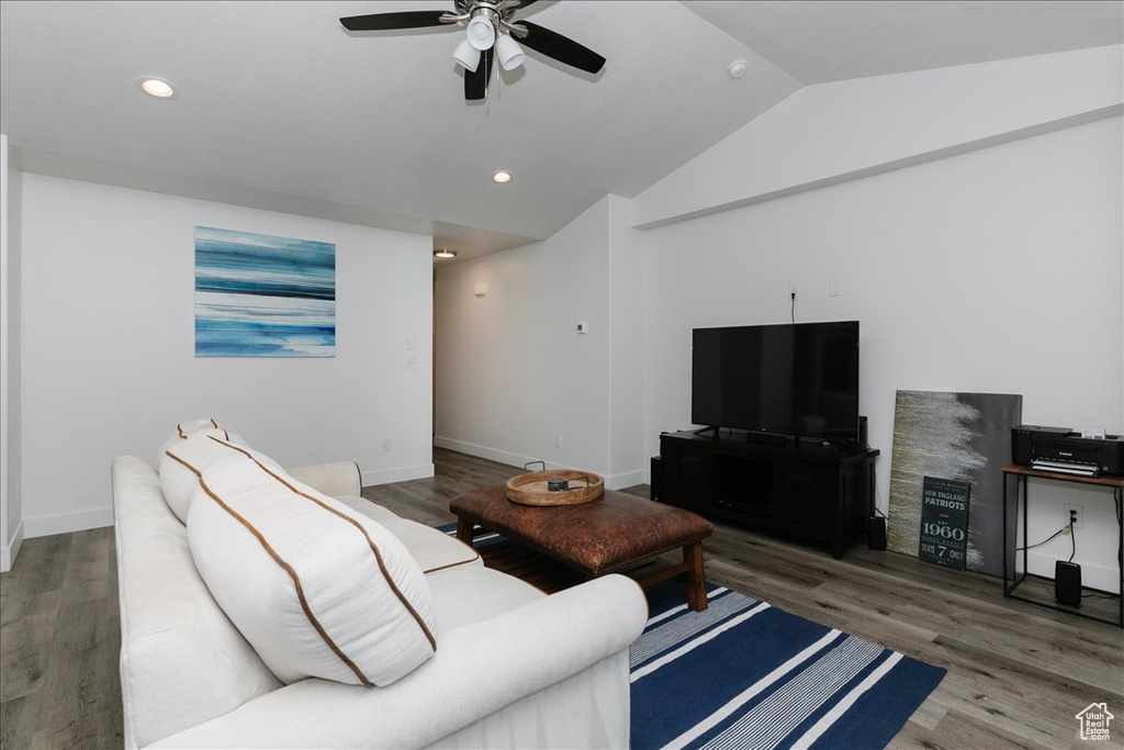 Living area featuring ceiling fan, wood finished floors, and lofted ceiling