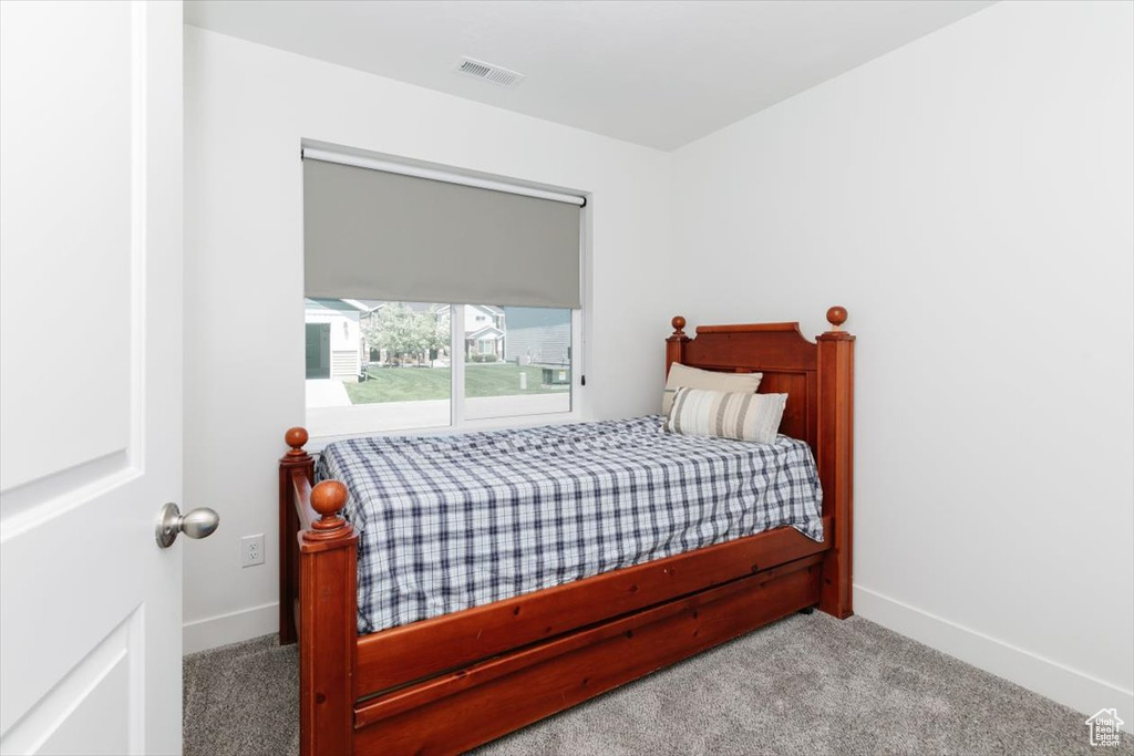 Bedroom with baseboards, carpet, and visible vents