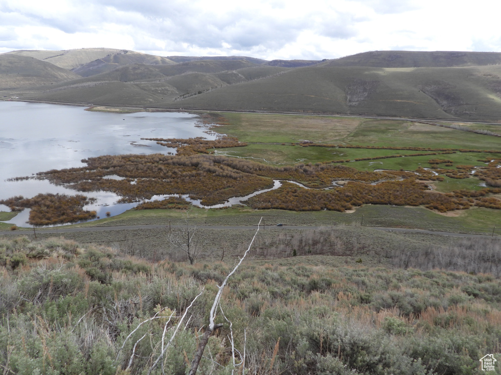 Property view of mountains featuring a water view