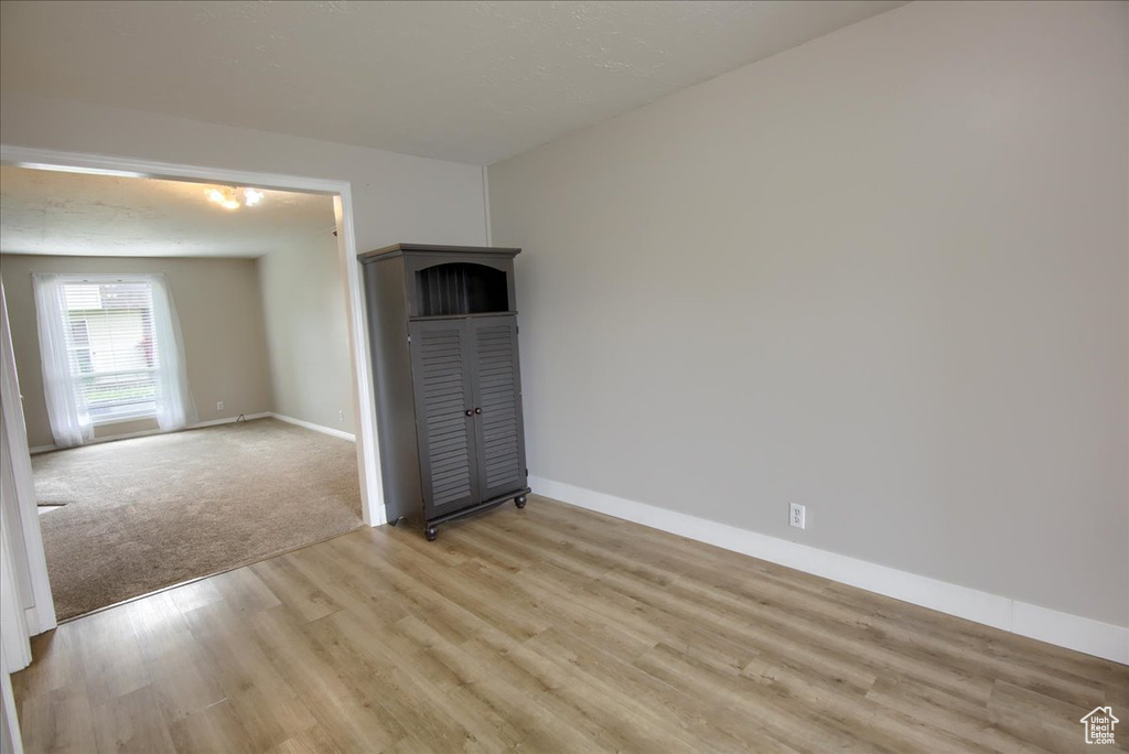 Unfurnished room with baseboards and light wood-style floors