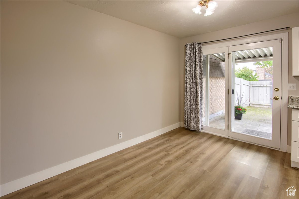 Spare room with light wood-type flooring and baseboards