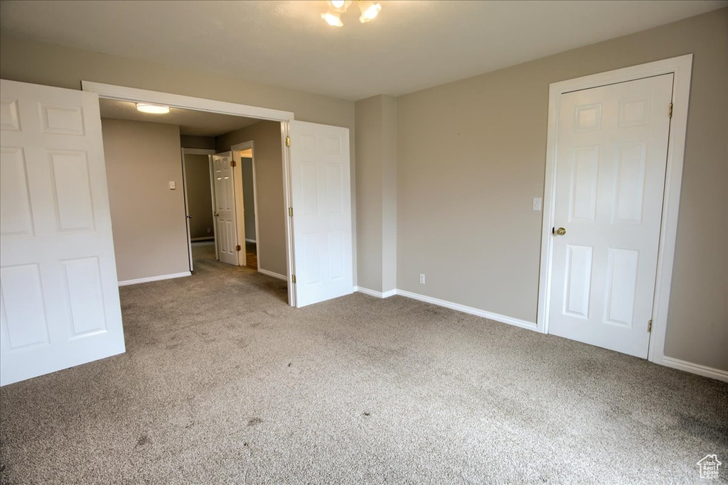 Unfurnished room with carpet and baseboards