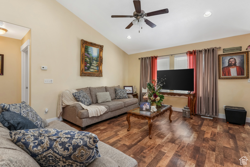 Living area featuring wood finished floors, baseboards, ceiling fan, lofted ceiling, and recessed lighting