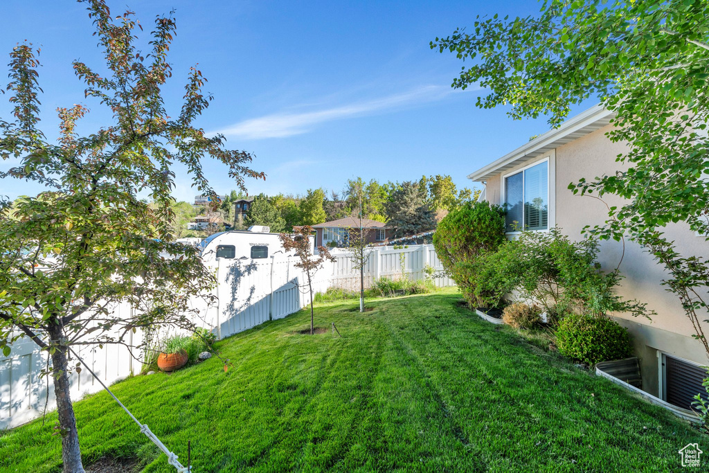 View of yard featuring fence