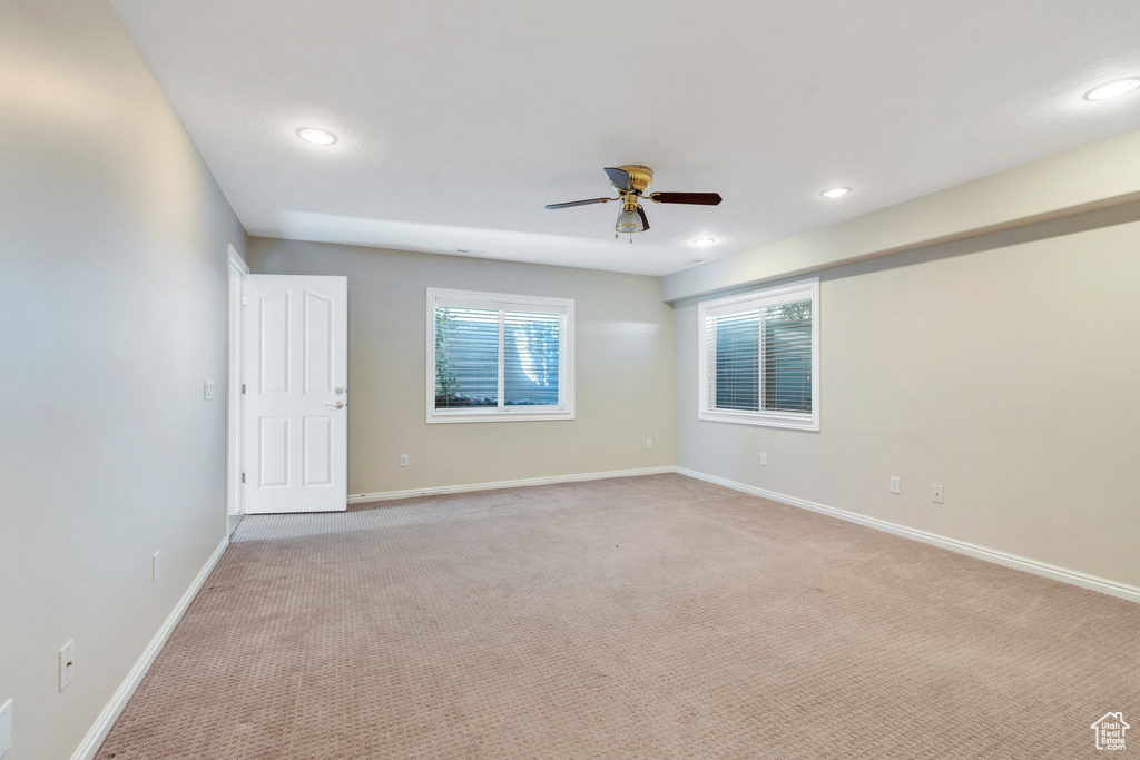Unfurnished room with light carpet, baseboards, ceiling fan, and recessed lighting