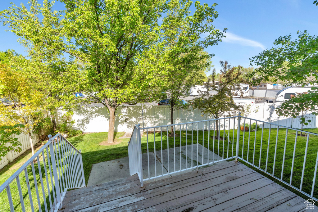 Wooden terrace with fence and a lawn