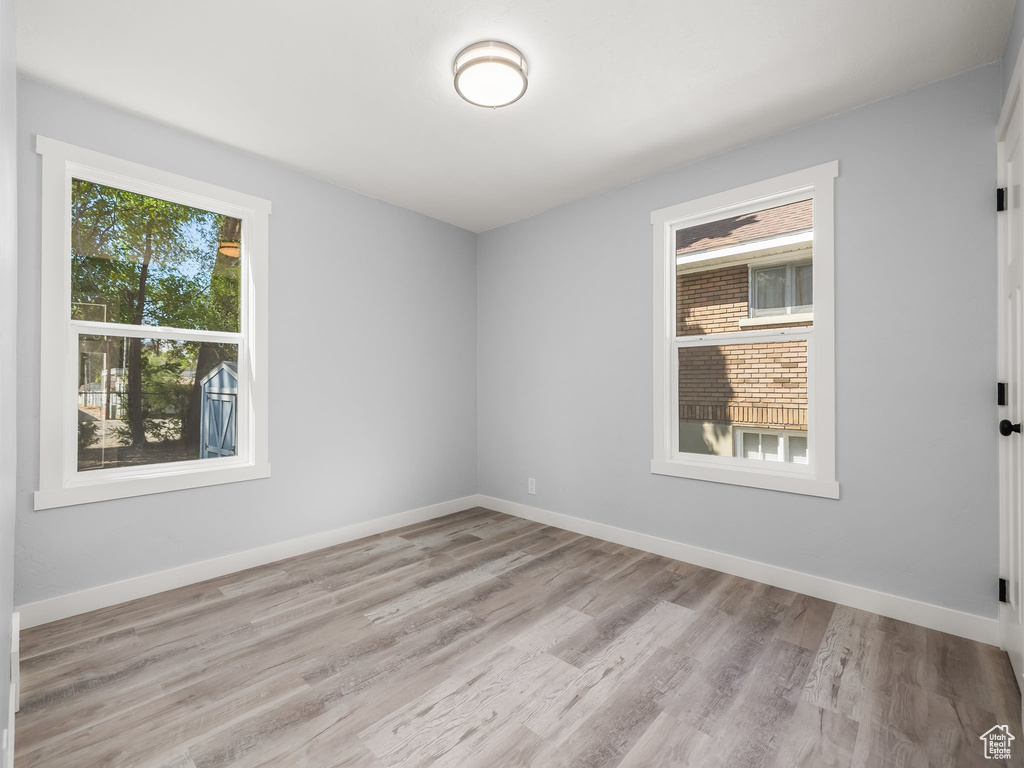 Unfurnished room featuring baseboards and wood finished floors