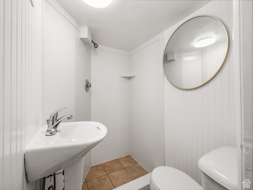 Bathroom featuring toilet and tile patterned flooring