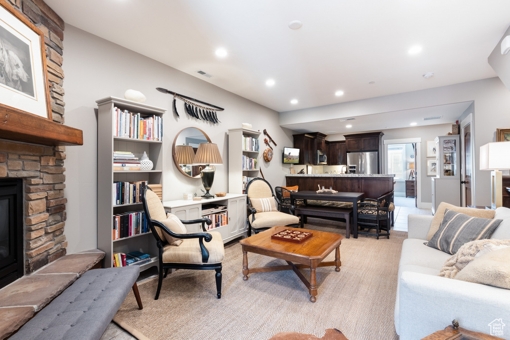 Living room with visible vents, recessed lighting, and a stone fireplace