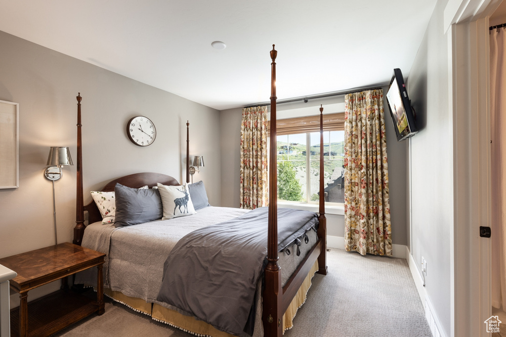 Bedroom featuring baseboards and light carpet