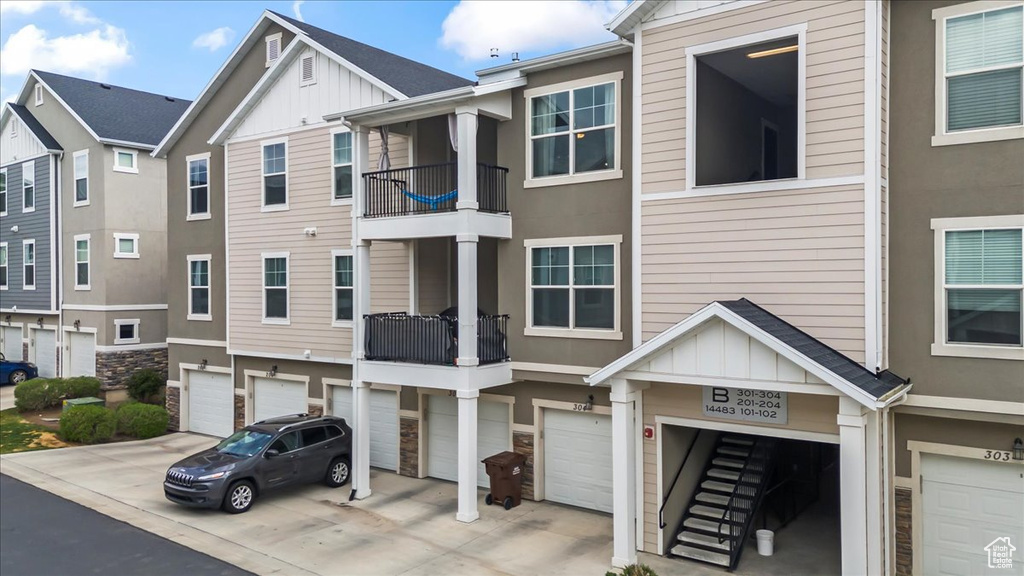 View of front of house featuring an attached garage, board and batten siding, and driveway
