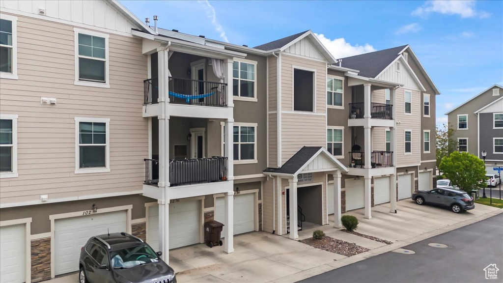 View of building exterior featuring driveway and a garage