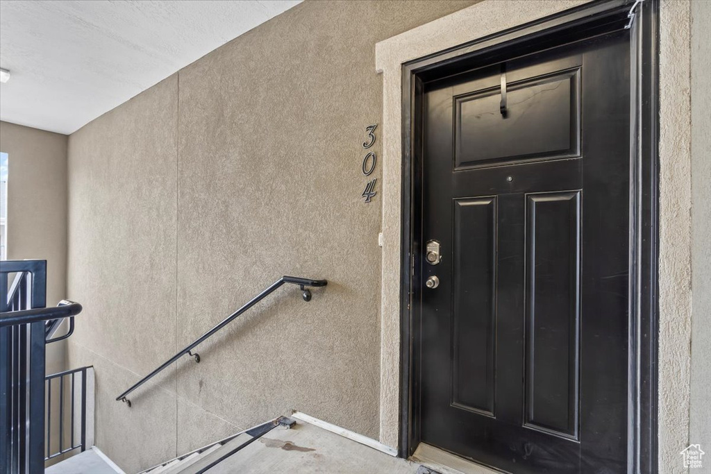 Entrance to property with stucco siding