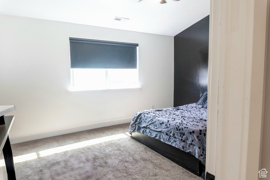 Bedroom featuring carpet floors and baseboards