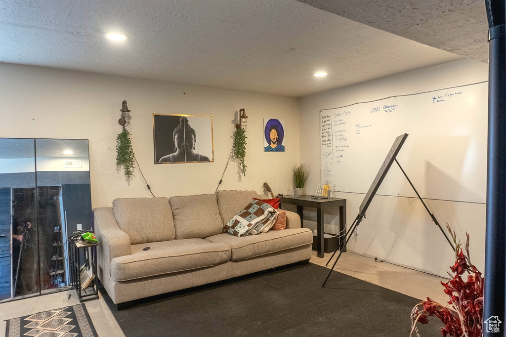 Living area featuring recessed lighting and a textured ceiling