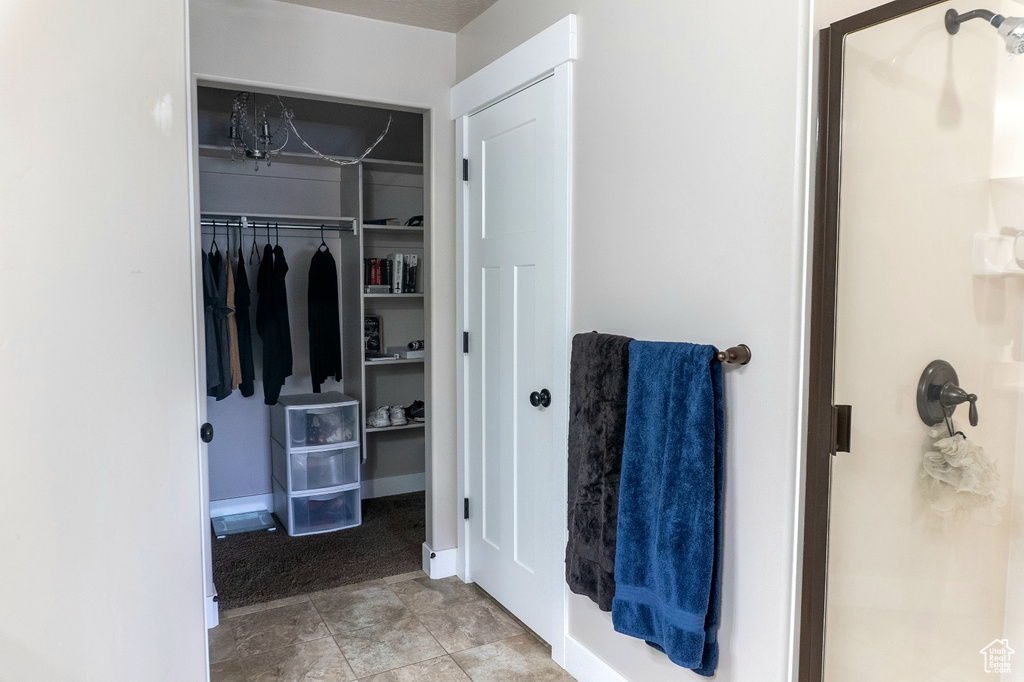 Full bath featuring a stall shower and a spacious closet