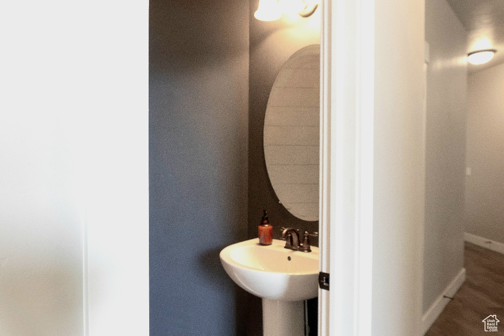 Bathroom featuring a sink and baseboards