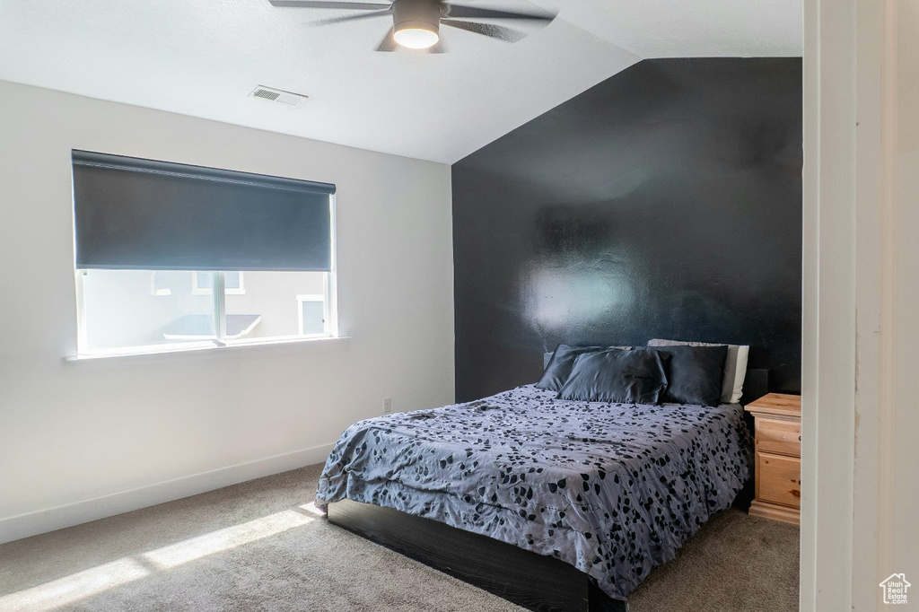 Bedroom with carpet, lofted ceiling, and ceiling fan