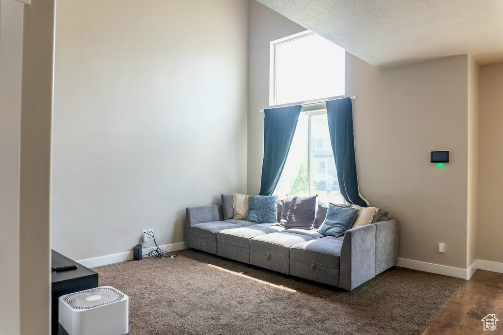 Living room with baseboards and carpet