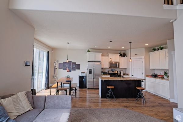 Living room with dark wood finished floors and recessed lighting