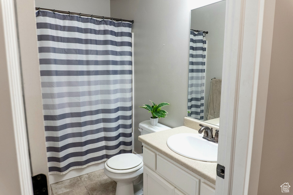 Bathroom featuring vanity, a shower with shower curtain, and tile patterned flooring