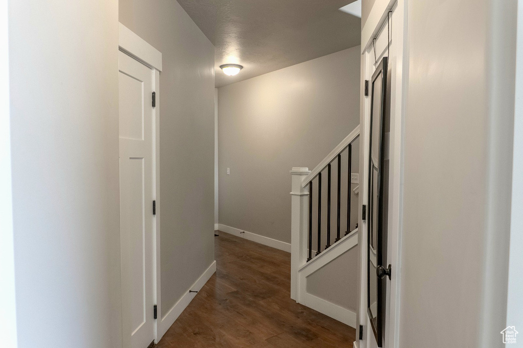 Hall with wood finished floors and baseboards