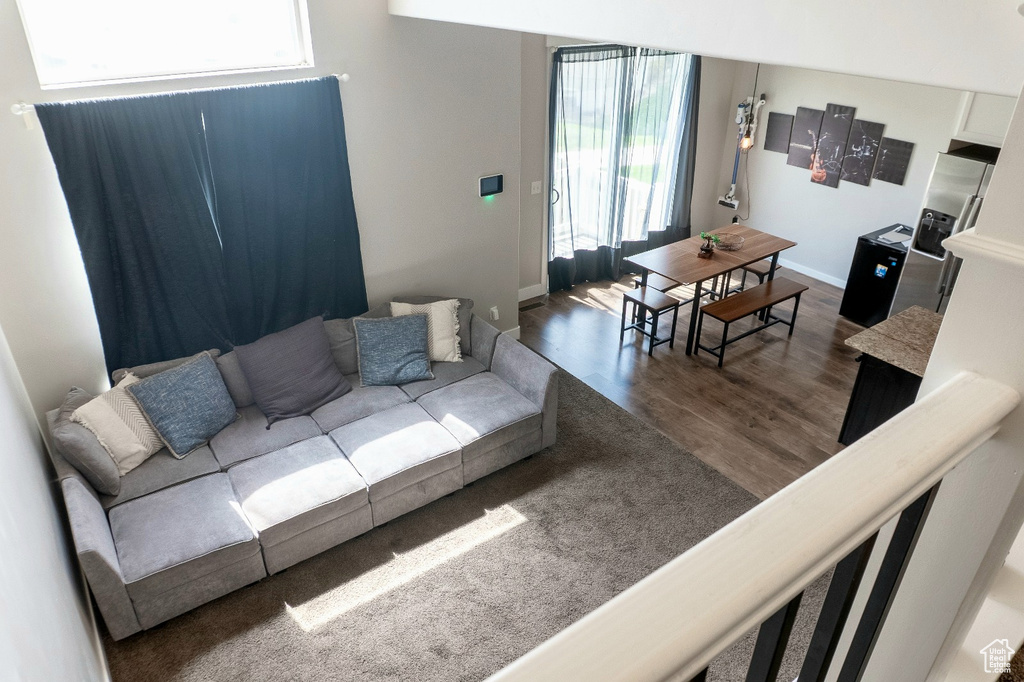 Living room with dark wood-style floors and baseboards