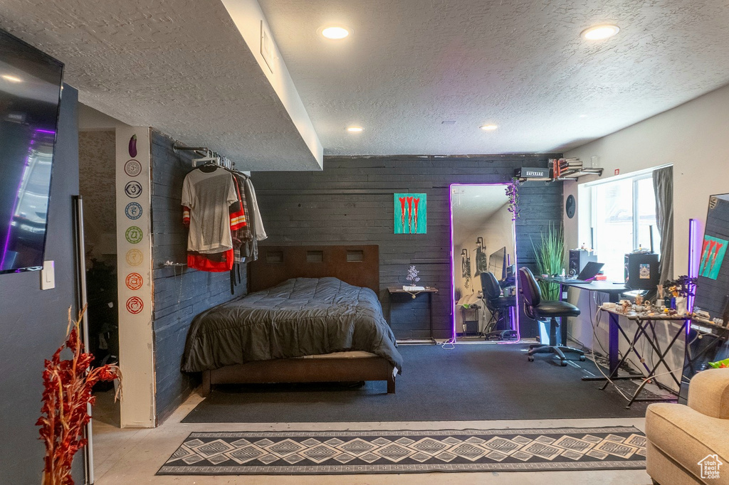 Carpeted bedroom featuring a textured ceiling and recessed lighting