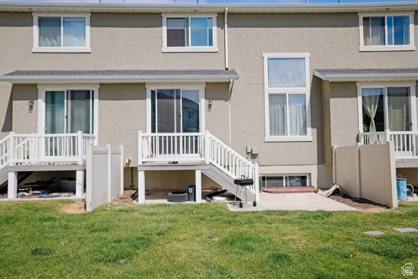 Back of property featuring stairs, stucco siding, and a deck