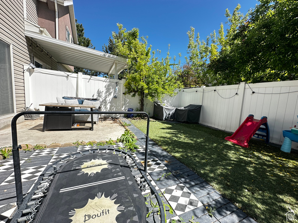 View of yard featuring a fenced backyard and a patio