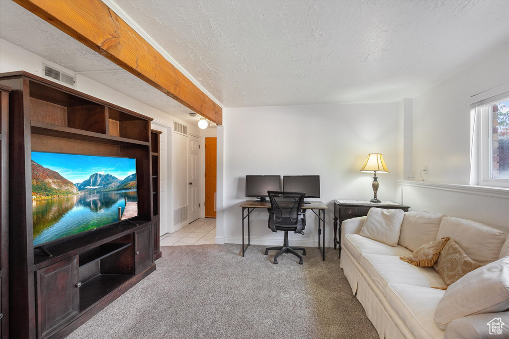 Carpeted office space featuring a textured ceiling and visible vents